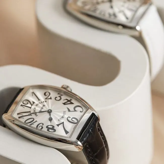 Franck Muller top-tier replicaquartz women's white dial black belt barrel-shaped leather strap watch front view