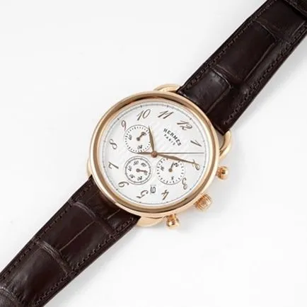Top Hermès men's watch with white dial, brown strap, quartz movement, and leather strap, front view.