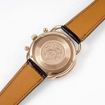 Top Hermès men's watch with white dial, brown strap, quartz movement, and leather strap, front view.