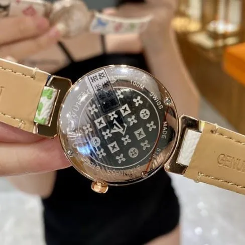 LV Louis Vuitton top-tier quartz gold disc leather strap watch front view